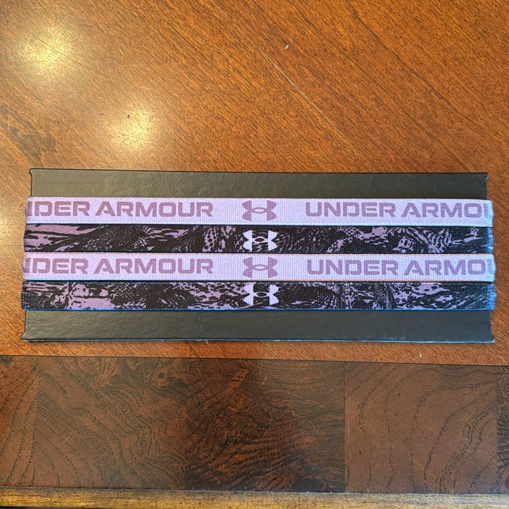 UnderArmour Women’s headbands, purple & black. Polyester and elastic material.
